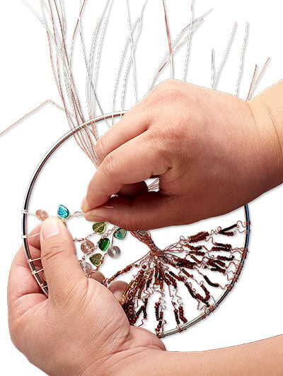 Beads being added to wire in loop
